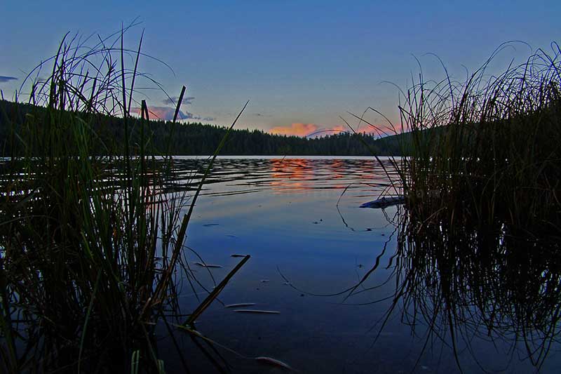 photo of sun setting below the horizon during the golden hour over Mohun Lake on Vancouver Island