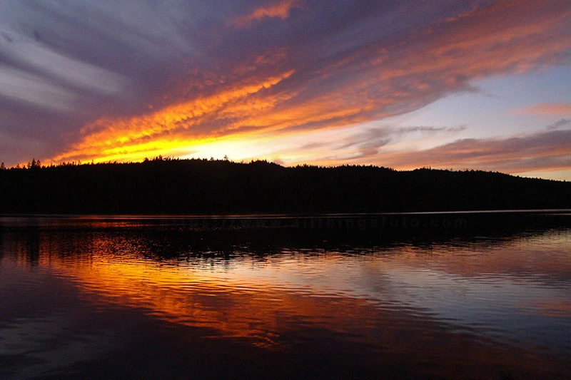 Photo of a spectacular sunset over Gray Lake on Vancouver Island.