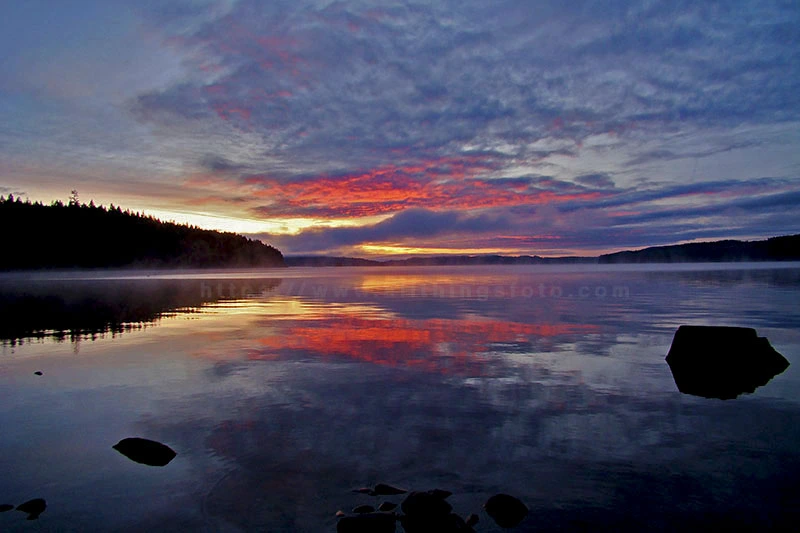 when photographing sunrises and sunsets this photo of a sunrise over Gosling Bay on Campbell Lake, Vancouver Island shows the Rayleigh Scattering effect.