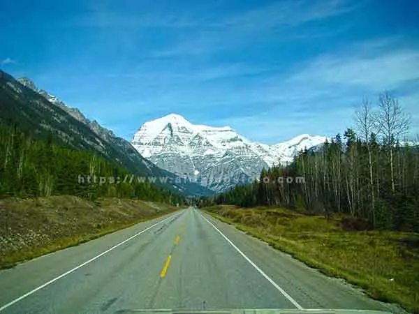 Image of majestic Mount Robson in British Columbia Canada where the highway is the leading line to the mountain.