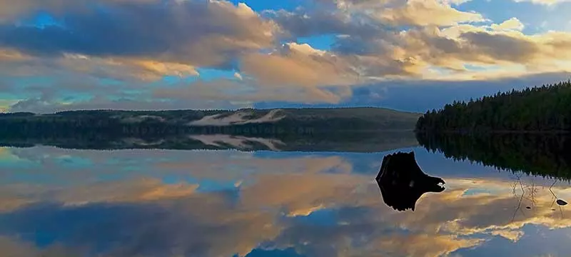 Photo of a reflection of clouds and fog over Lower Campbell Lake on Vancouver Island Canada