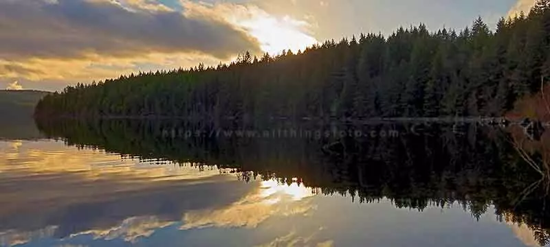 image of capturing the perfect reflection of a sunset over Lower Campbell Lake on Vancouver Island Canada