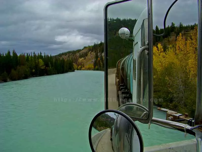 photo of the perfect reflection crossing over a river in the Caribou Region of British Columbia Canada