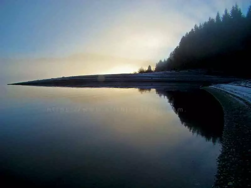 landscape photo of the fog lifting over Upper Campbell Lake