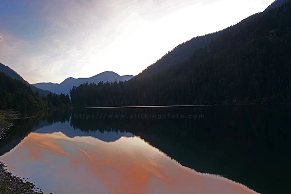 Photo of Drum Lake just before sunset when the sun drops behind the mountains