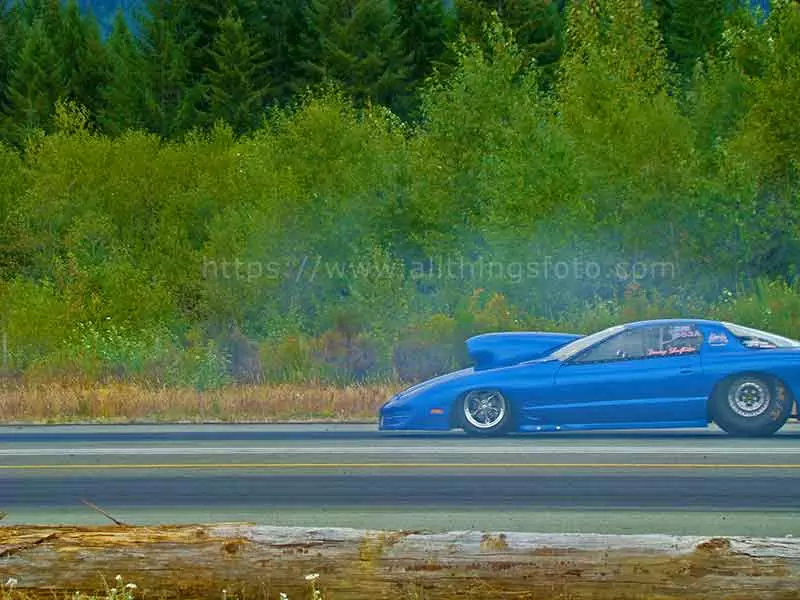 photo of a blue funny car drag racing on the Port Alberni drag strip