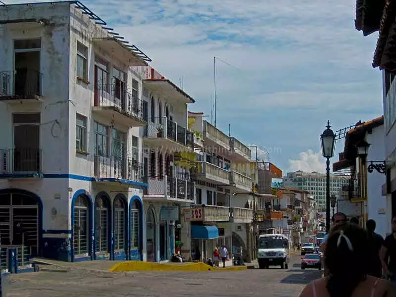 photo of a city street with traffic heading towards the camera