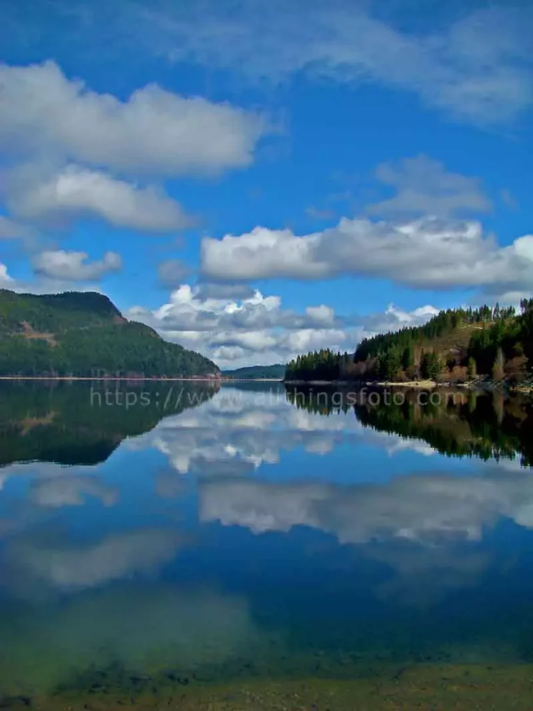 photo of clouds reflecting in the water of Upper Campbell Lake on Vancouver Island BC Canada